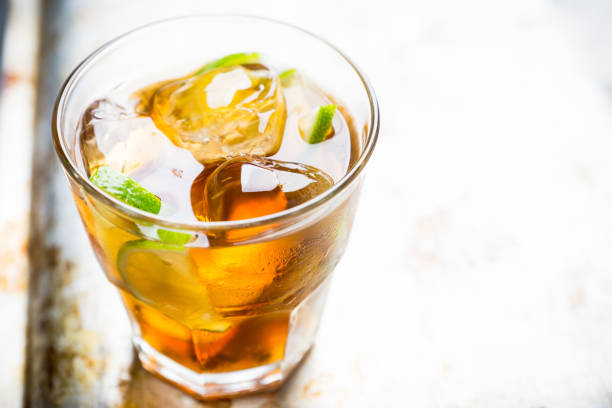 Cuba libre cocktail with cola and lime. Selective focus.