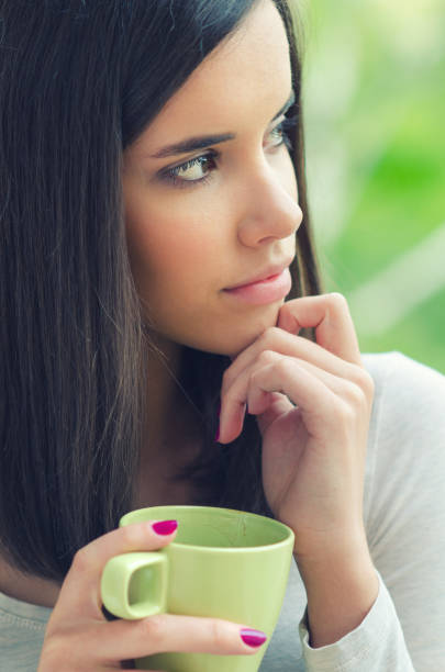 istock Woman drinking coffee at home 1130887626