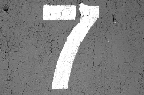 istock Number 7 in stencil on metal wall in black and white. 1130887755