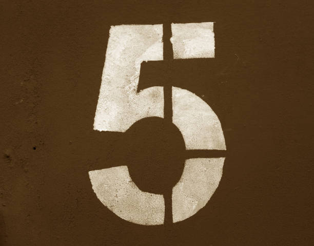 istock Number 5 in stencil on metal wall in brown tone. 1130887952