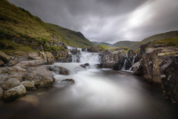 istock Dark and moody overcast over waterfall with long exposure Lake District England 1130888229