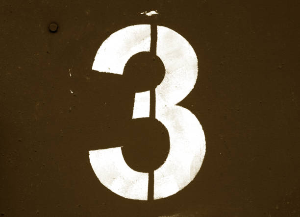 istock Number 3 in stencil on metal wall in brown tone. 1130888863