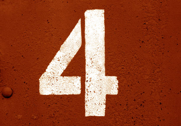 istock Number 4 in stencil on metal wall in orange tone. 1130889115