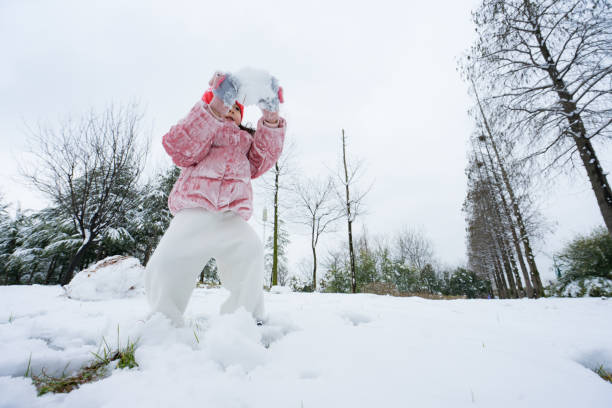 istock A young girl playing in the snow 1130889606