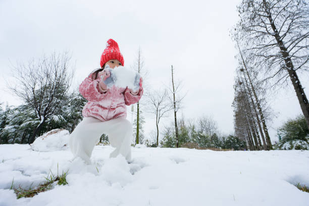A young girl playing in the snow