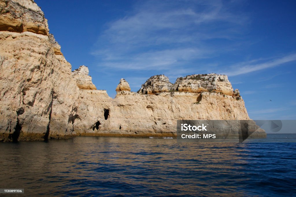 Cliff located in Portugal, seen from the sea The tip of land of incoming cliffs to enter by the sea, located in Portugal, sight of the sea. Algarve Stock Photo