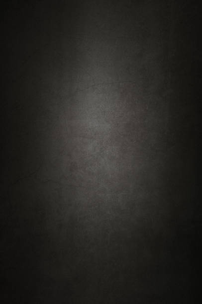 istock Background wall of aged textured old plaster black. 1130891294