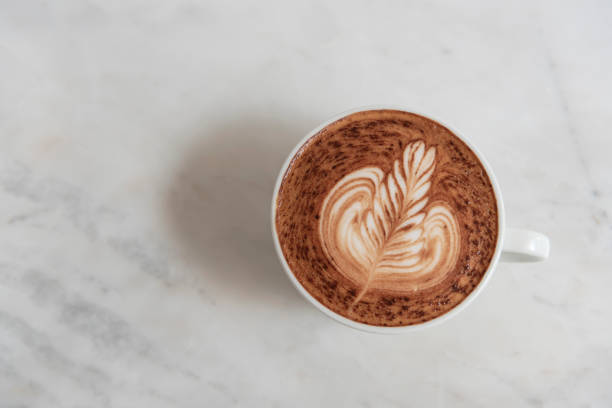 istock mocha coffee with frothy foam, top view on table in cafe. 1130892827