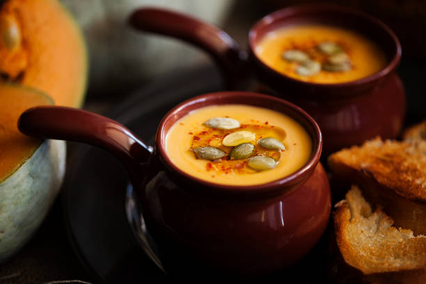 cream soup of roasted pumpkin with croutons close-up. halloween holiday food. - portion pumpkin vegetable black imagens e fotografias de stock