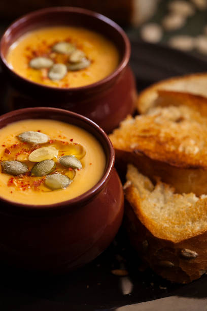 sahgensuppe aus geröstetem kürbis mit croutons aus nächster nähe. halloween feiertagskost. - portion pumpkin vegetable black stock-fotos und bilder