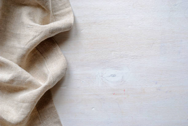 This is linen fabric. Bottom linen fabric border in a natural neutral woven material over painted white wood fabric edge stock pictures, royalty-free photos & images