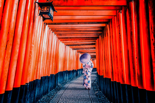 Fushimi Inari Taisha shrine in Kyoto Girl with traditional dress in Fushimi Inari Taisha shrine in Kyoto, Japan shinto photos stock pictures, royalty-free photos & images