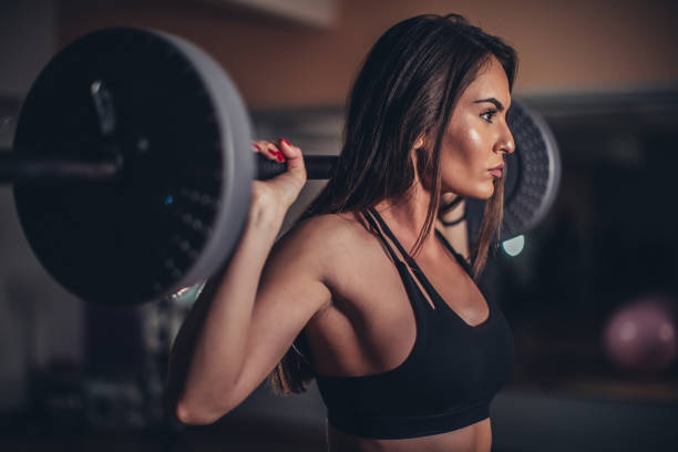 istock Fit lady exercising with weights in gym 1130895639