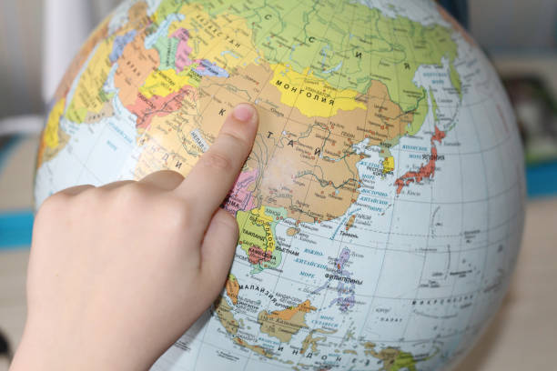 istock The child is studying geography. Finger pointing to the globe. 1130896259