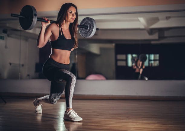 istock Fit young lady training with weights in gym 1130896971