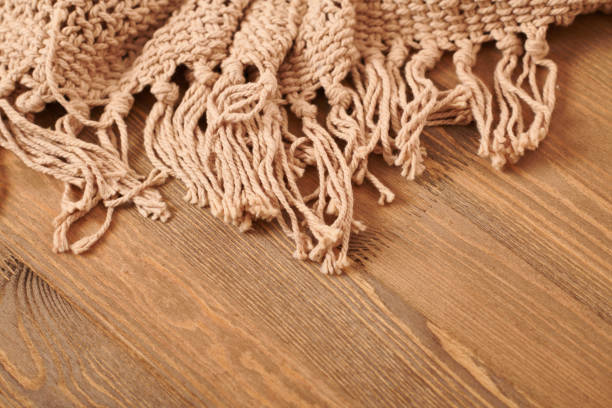 istock brown knitted blanket on wooden background 1130897584