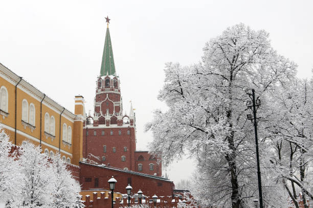 istock Snowfall in Moscow, Kremlin tower and wall with snow covered trees 1130897747