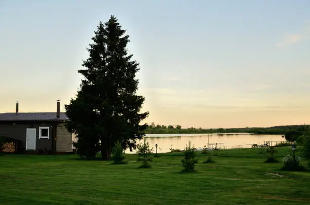 The house on the shore of a lake on beautiful summer evening