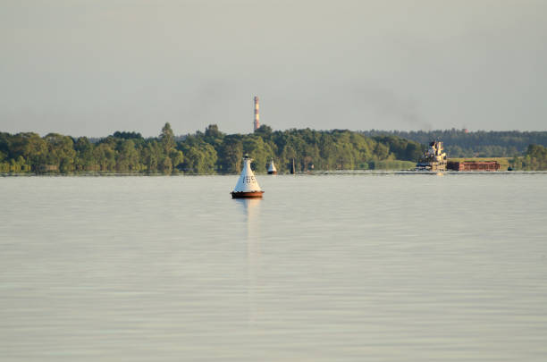 The white buoy on the Volga river on a sunny summer evening