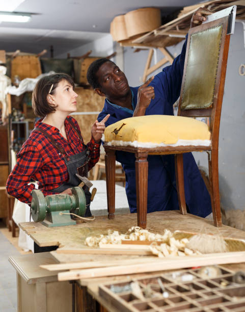 istock Carpenters inspecting old wooden chair 1130900832