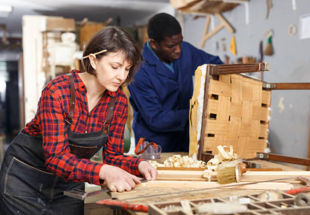 istock Artisans in process of renewing armchair 1130900836