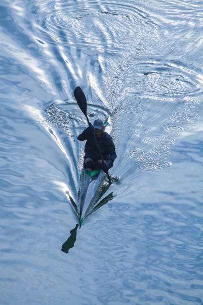Athlete man rowing alone in a kajak on Danube river.