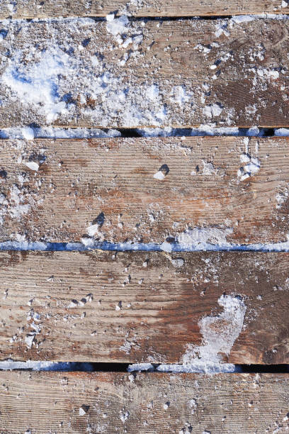 istock Wooden boards covered with snow and ice cubes, background 1130902499
