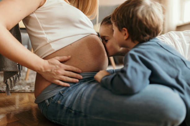 istock Kids and mom expecting a new baby 1130904333