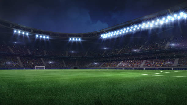 moderno stadio di calcio illuminato da proiettori ed erba verde vuota - european architecture flash foto e immagini stock