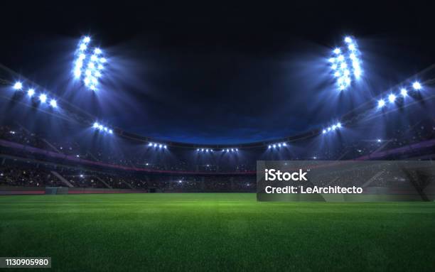 Universal Grass Stadium Illuminated By Spotlights And Empty Green Grass Playground Stock Photo - Download Image Now