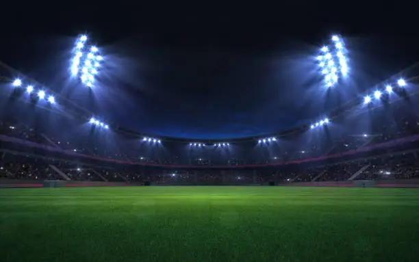 Photo of universal grass stadium illuminated by spotlights and empty green grass playground