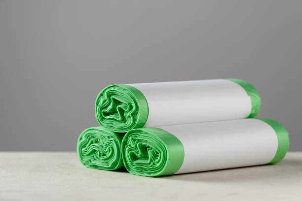 Three roll green eco garbage bag with copy space isolated on grey background. Horizontal shot of three roll green eco garbage bag with copy space isolated on grey background. biodegradable photos stock pictures, royalty-free photos & images