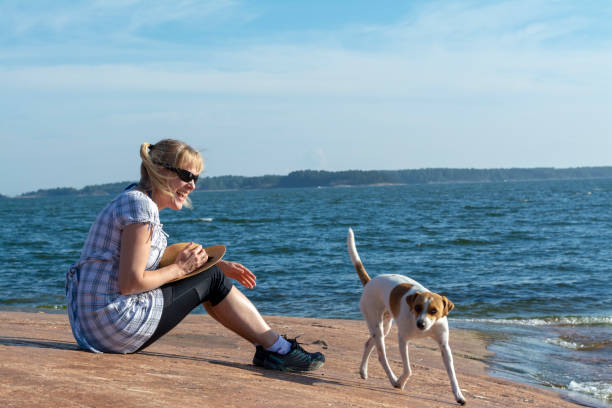 A kayaker enjoys his breakfast in the morning light on a small island in the Stockholm archipelago.