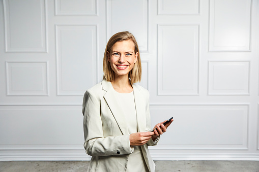 Confident businesswoman with phone, smiling