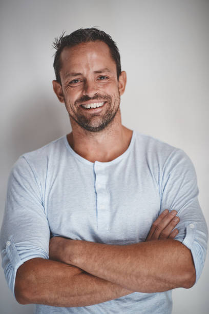 istock Entrepreneur smiling with his arms crossed on a gray background 1130907805