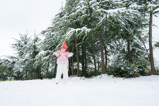 A young girl playing in the snow