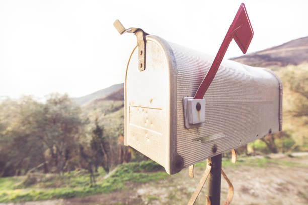Metal mail box with typical American style, behind you see a countryside landscape