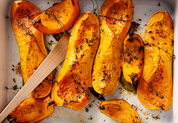 Dish of baked Butternut squashes ready to eat. stock photo