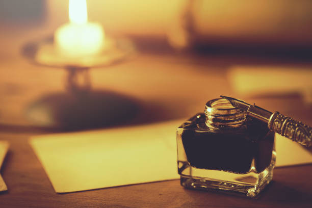 istock writing letter with quill pen and ink in candlelight 1130913488
