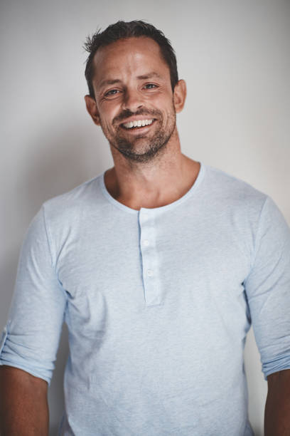 istock Male entrepreneur smiling while standing against a gray background 1130914402