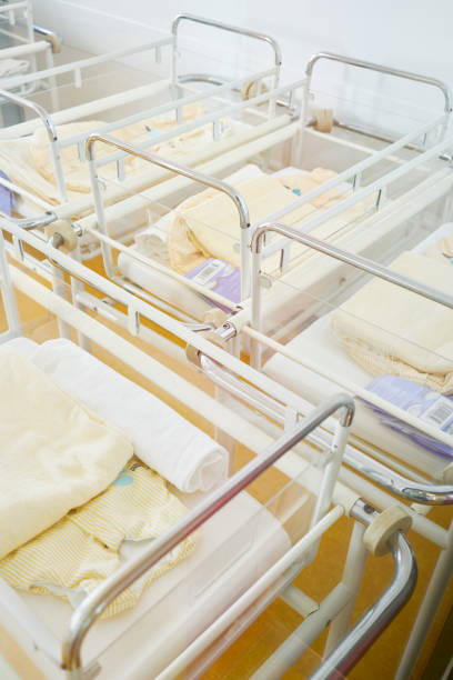 Hospital Beds Room Bird's-eye view Hospital with 4 cots in a room without baby in front of a wall no one knows maternity ward stock pictures, royalty-free photos & images