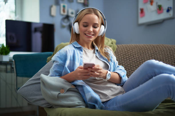 istock Beautiful young lady listening music and using cellphone 1130914877