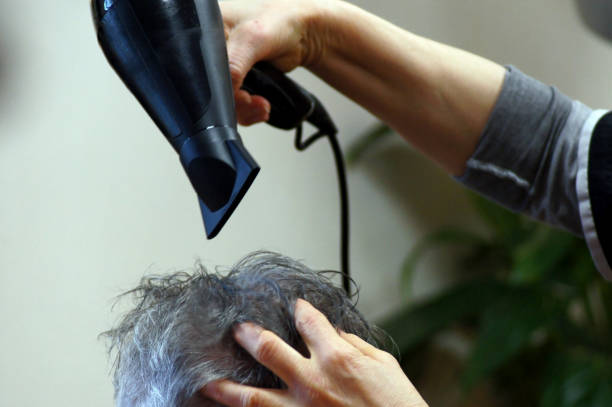 Men hair drying at hairdresser Men hair drying at hairdresser körperpflege stock pictures, royalty-free photos & images