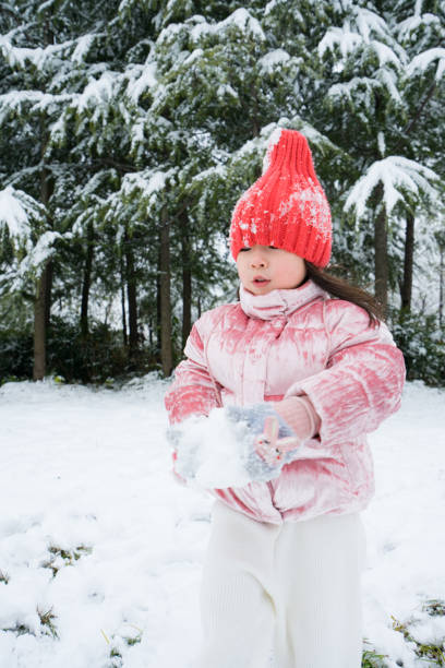 A young girl playing in the snow