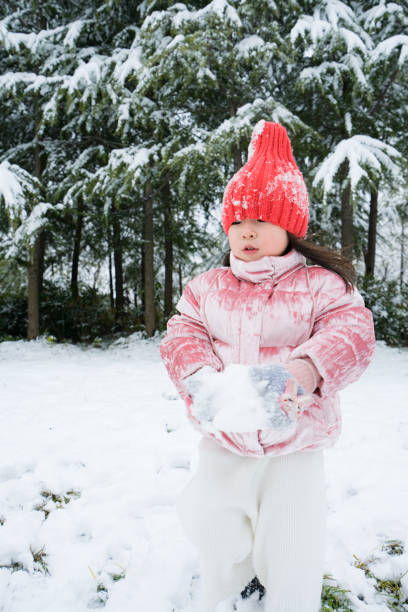 A young girl playing in the snow