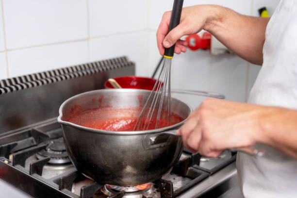 istock Pastry Chef in the kitchen cooking a red strawberry marmalede cream. 1130916458