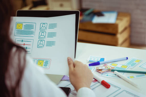 istock Closeup hand of designers mobile application with sketch drawing application work in the office. User experience Design concept. 1130916827