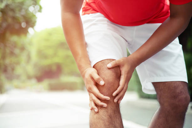 istock Runner touching painful twisted or broken ankle. Athlete runner training accident. Sport running ankle sprained sprain cause injury knee. and pain with leg bones. Focus color red on to show pain. 1130916981