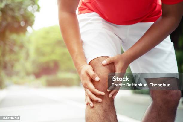 Runner Touching Painful Twisted Or Broken Ankle Athlete Runner Training Accident Sport Running Ankle Sprained Sprain Cause Injury Knee And Pain With Leg Bones Focus Color Red On To Show Pain Stock Photo - Download Image Now