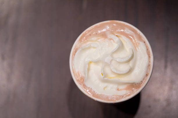 Cocoa or hot chocolate with whipped cream on wood table